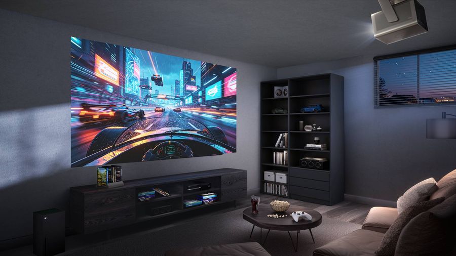 Le vid&eacute;oprojecteur 4K Hisense C3 Ultra install&eacute; au plafond projette une sc&egrave;ne de course automobile sur le mur du salon.