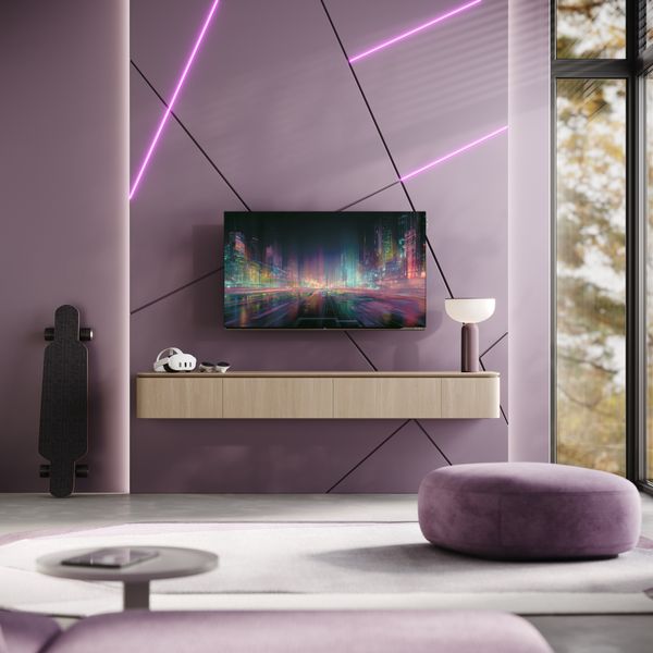 Le t&eacute;l&eacute;viseur OLED Loewe We. SEE 48 OLED dc est install&eacute; au mur d'un salon contemporain aux &eacute;clairages color&eacute;s.