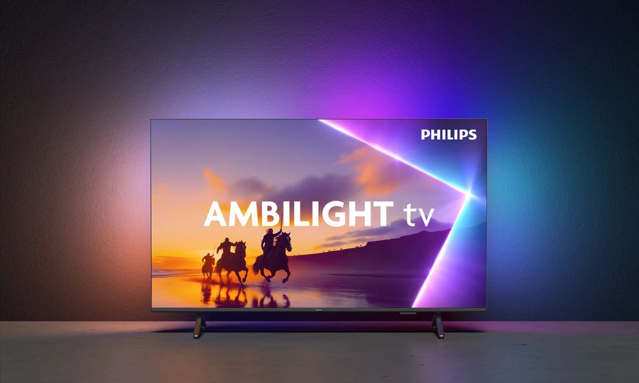 TV Philips 55PUS8550 Ambilight  Téléviseur Philips 55PUS8550 de 65 pouces avec technologie Ambilight projetant des couleurs dynamiques sur le mur arrière.