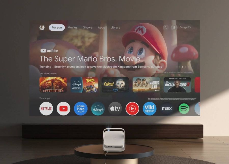 Le projecteur Xgimi Elfin Flip Plus diffuse l&rsquo;interface Google TV avec plusieurs applications de streaming affich&eacute;es sur un mur.